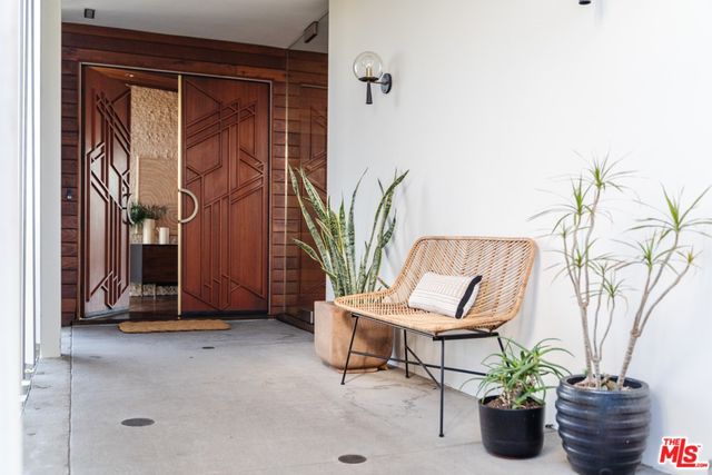 a view of a patio with dining table and chairs