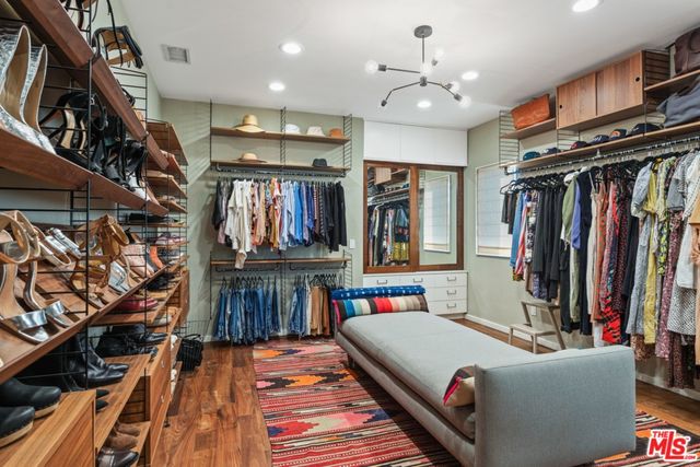 a living room with lots of furniture and fan