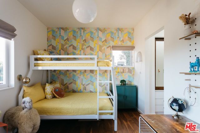 a bathroom with a granite countertop sink mirror vanity and toilet