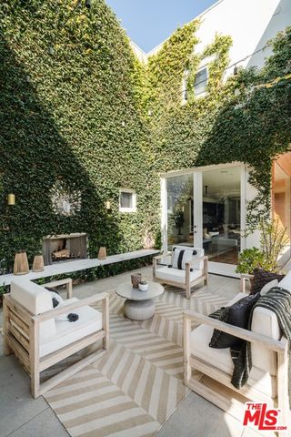 a view of a patio with table and chairs under an umbrella