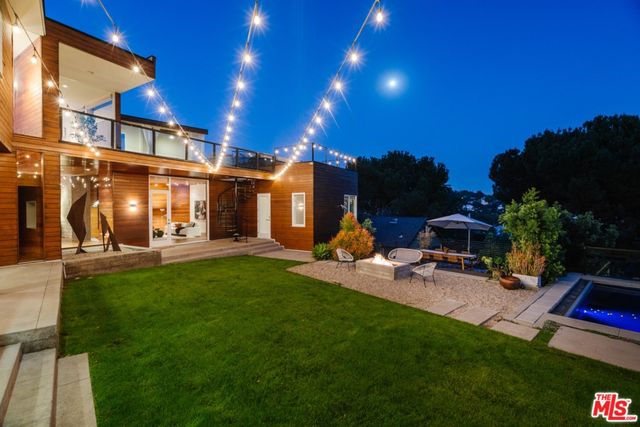 a view of a patio with couches table and chairs and potted plants