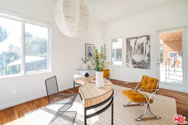 a view of a dining room with furniture window and wooden floor
