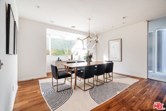 a kitchen with stainless steel appliances a sink counter space and chairs