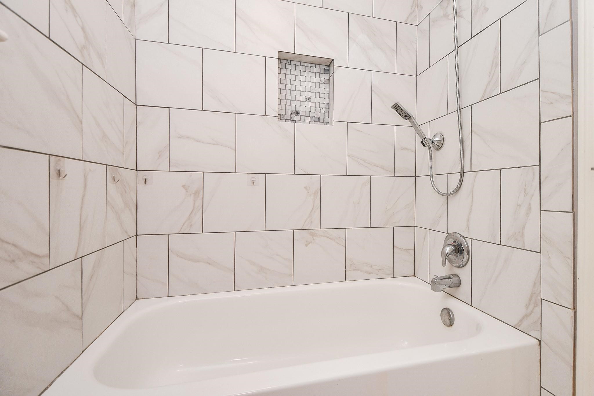 2331 Wren Meadow Road Richmond, TX 77406 - Photo 33 of 37 Enjoy luxury spa-like treatment in your upstairs shower bath combo that is both modern and beautiful!
