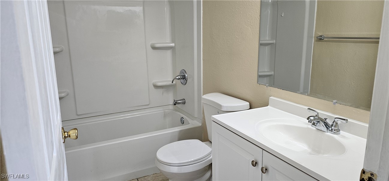 4731 15th Street Southwest Lehigh Acres, FL 33973 - Photo 14 of 19 a bathroom with a sink toilet and a bathtub