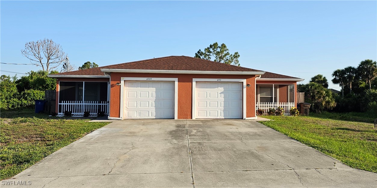4731 15th Street Southwest Lehigh Acres, FL 33973 - Photo 2 of 19 a front view of a house with a yard and potted plants