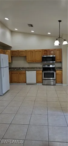 a kitchen with stainless steel appliances a stove a sink and a counter top space