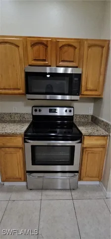 a stove top oven sitting inside of a kitchen