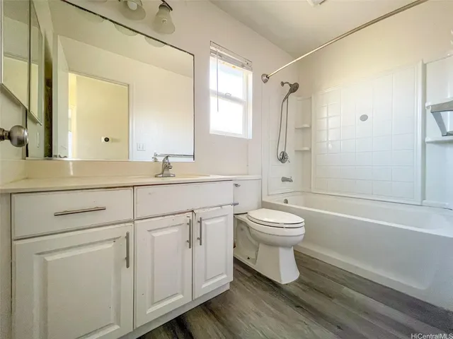 a bathroom with a toilet a sink a mirror a bathtub and shower