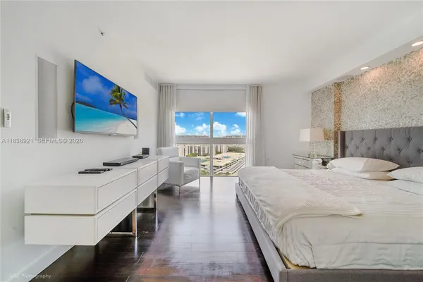 a bedroom with a bed and a flat screen tv