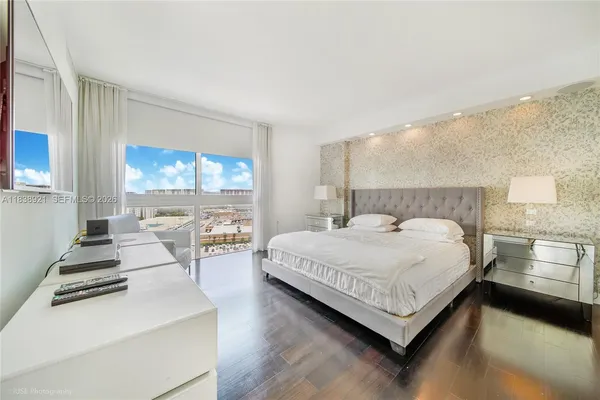 a bedroom with a bed and a large window