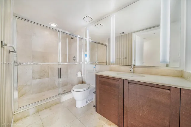 a bathroom with a double vanity sink toilet and shower