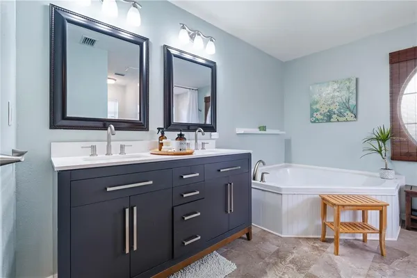 a view of a bathroom with a shower and a mirror