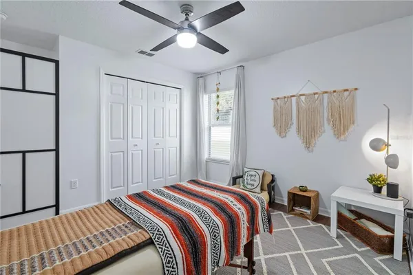 a bedroom with a bed and a chandelier