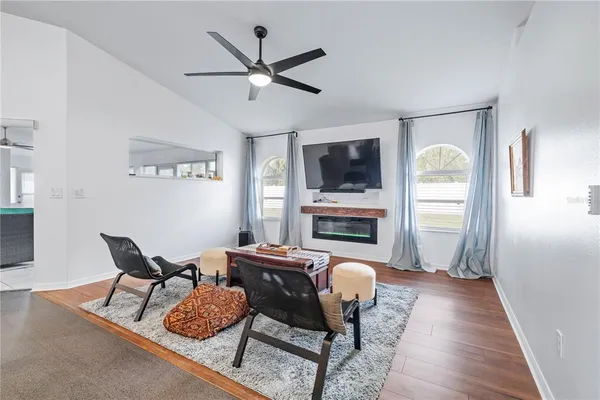 a living room with furniture a fireplace and a flat screen tv