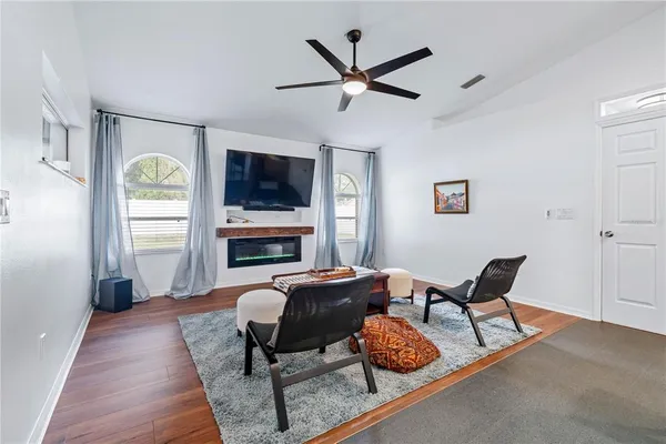 a living room with lots of furniture and kitchen view