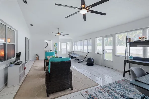 a living room with patio furniture and a window