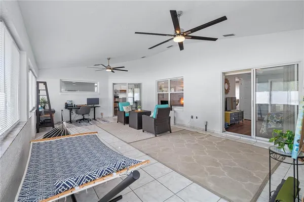 a view of a hallway with furniture and windows