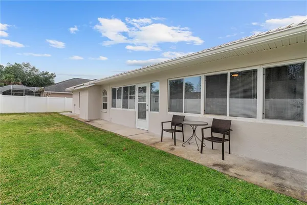 a view of yard with swimming pool and green space