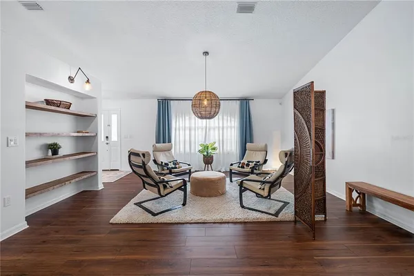 a dining room with furniture and wooden floor