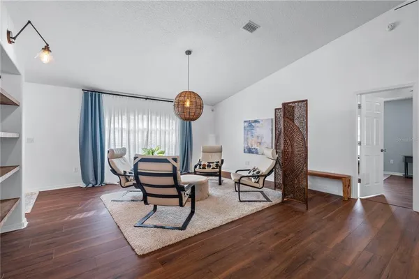 a living room with furniture a window and gym equipment