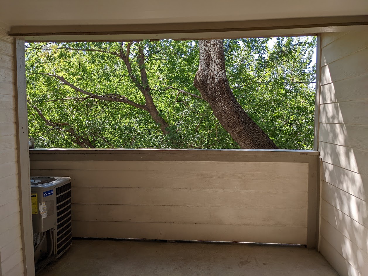 2500 Burleson Road, Unit 615 Austin, TX 78741 - Photo 11 of 13 Balcony Patio Ideal for Relaxing and Fresh Air Sheltered by LargeTrees