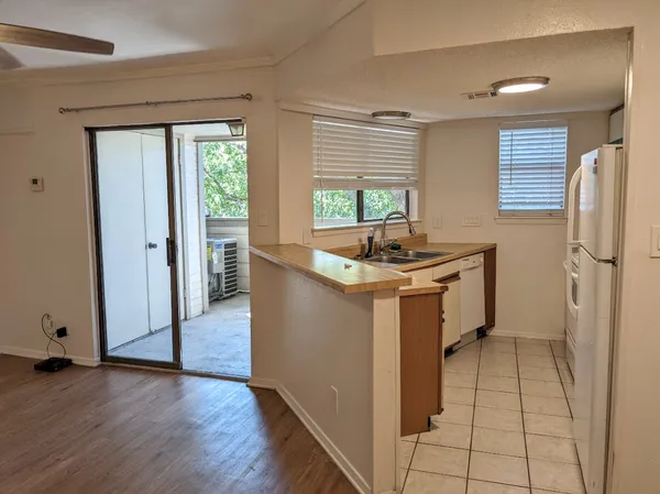 a kitchen with sink cabinets and window
