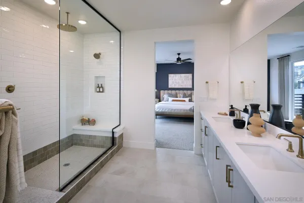 a en suite spacious bathroom with a double vanity sink a mirror and shower