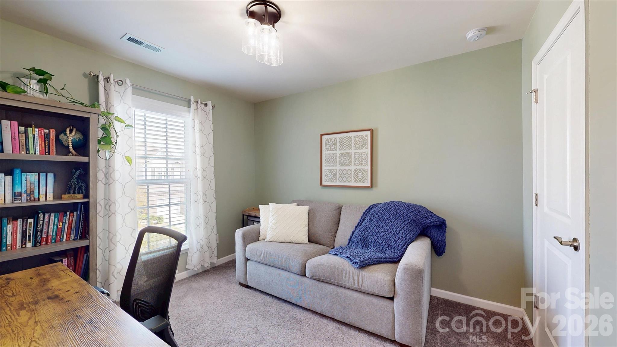 827 Canoe Song Road Fort Mill, SC 29708 - Photo 20 of 33 a living room with furniture and a book shelf
