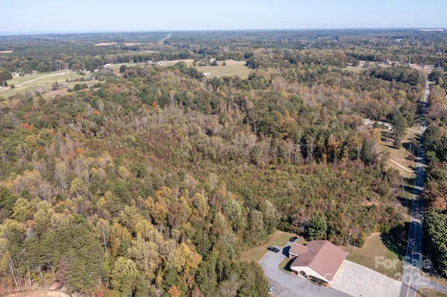 an aerial view of house with yard and mountain view