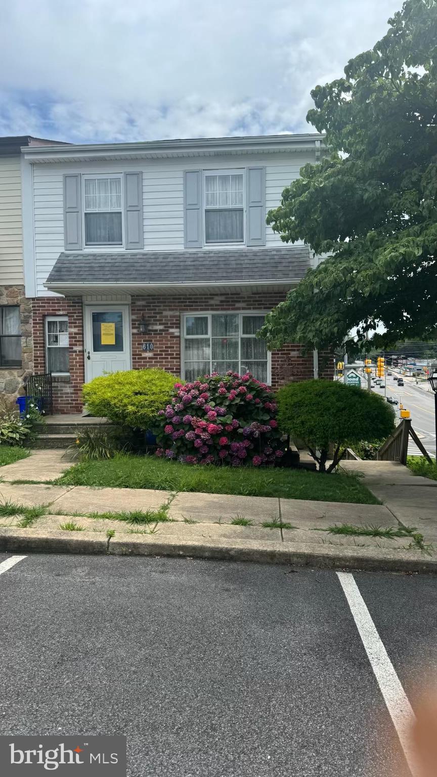 a front view of house with a garden