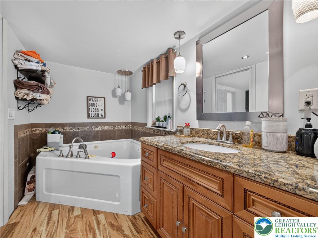 2628 Levans Road Coplay, PA 18037 - Photo 47 of 54 Indulge in a tranquil retreat with this bathroom's elegant granite vanity and inviting soaking tub.