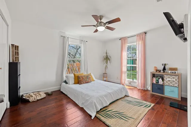 a bedroom with a bed and wooden floor