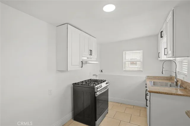 a kitchen that has a sink and a stove