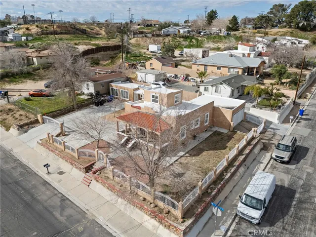 an aerial view of a house with yard