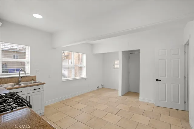 a view of a livingroom with wooden floor and a window