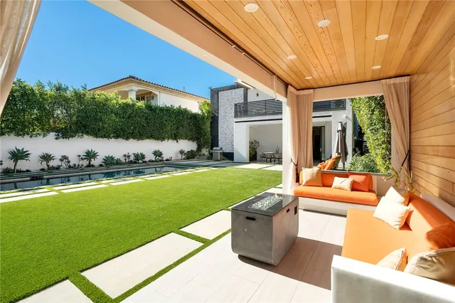 a view of swimming pool with a yard and seating area