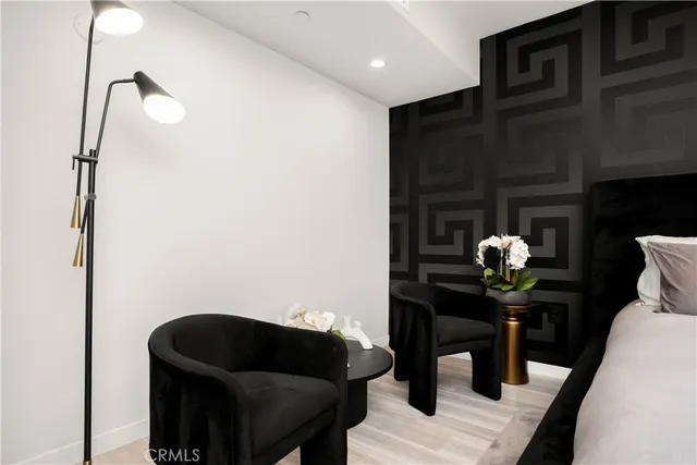 a bedroom with a bed and a large window