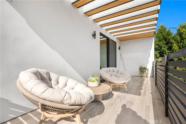 a view of a two chairs in the balcony