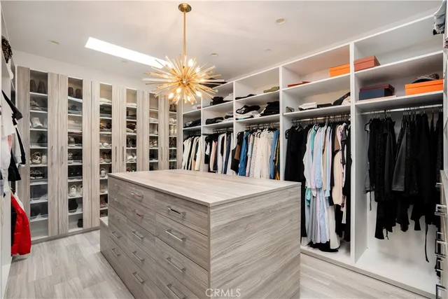 a bed sitting in a spacious bedroom next to a window