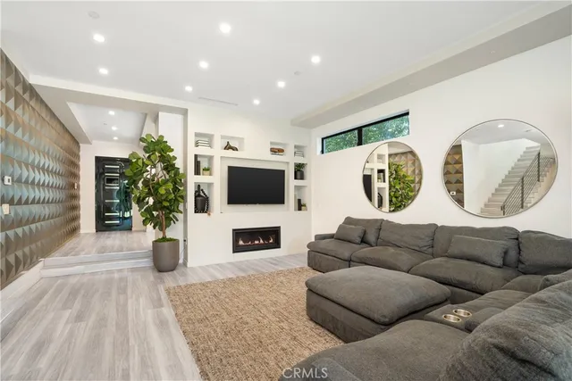 a living room with furniture fireplace and flat screen tv