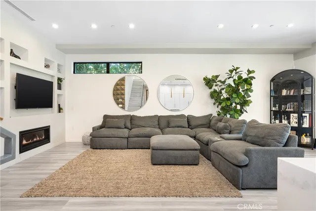 a living room with furniture a mirror and a window