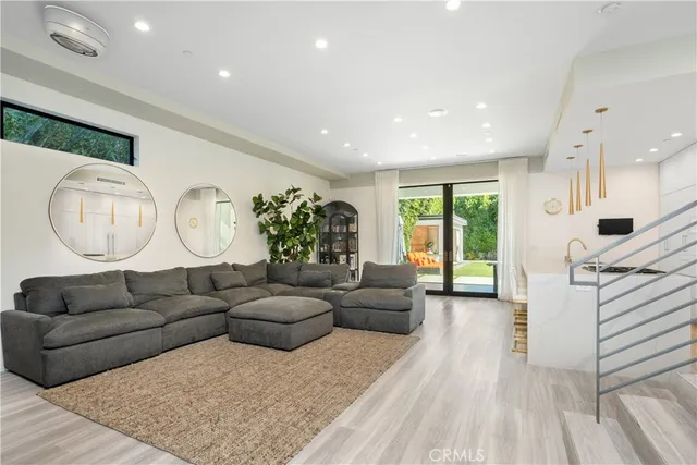 a kitchen with a sink cabinets and wooden floor