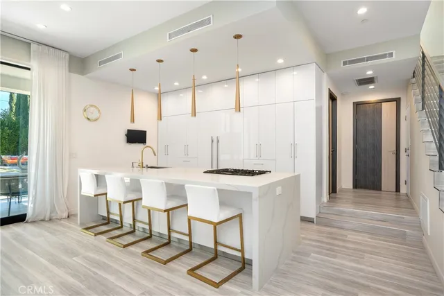 a kitchen with stainless steel appliances a refrigerator and a stove