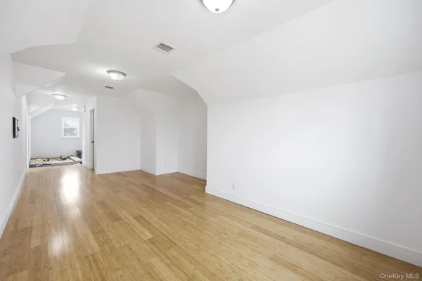 a view of an empty room and wooden floor
