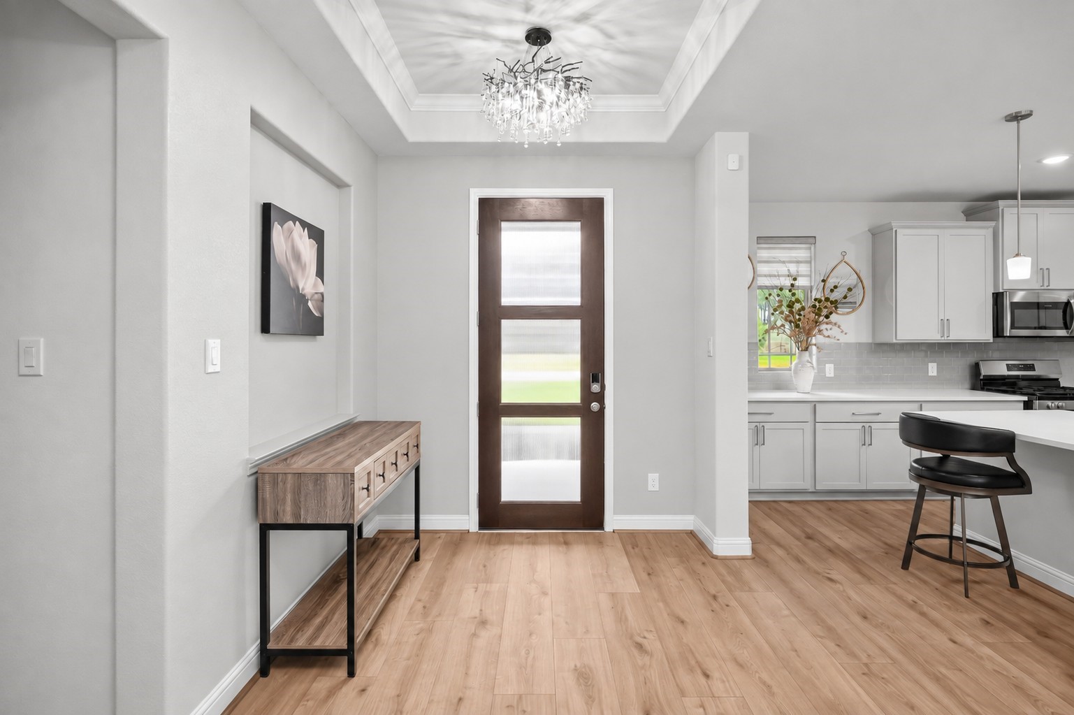 13419 Maverick Trail Road Conroe, TX 77303 - Photo 31 of 48 Welcoming foyer with tray ceiling and modern chandelier.