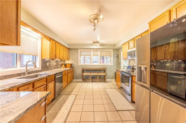 a large kitchen with granite countertop a large window and a counter space