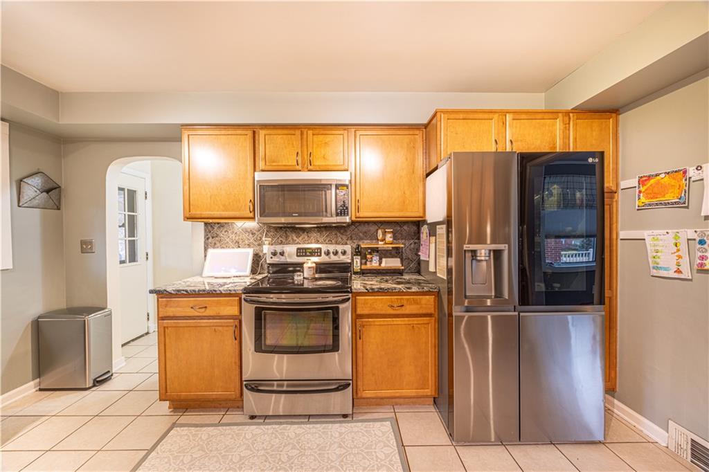 63 Evergreen Terrace Uniontown, PA 15401 - Photo 13 of 25 a kitchen with stainless steel appliances granite countertop a refrigerator and a stove