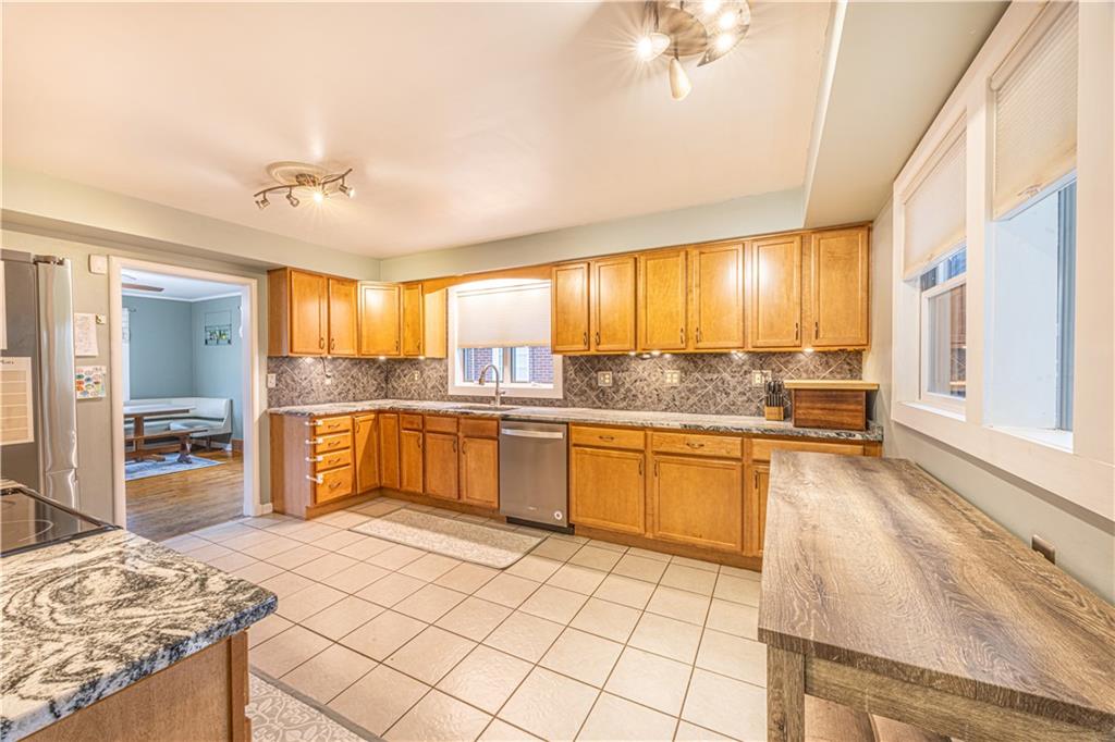 63 Evergreen Terrace Uniontown, PA 15401 - Photo 14 of 25 a large kitchen with granite countertop a stove a sink a refrigerator and dining table