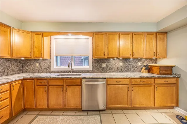 a kitchen with stainless steel appliances granite countertop a sink and cabinets